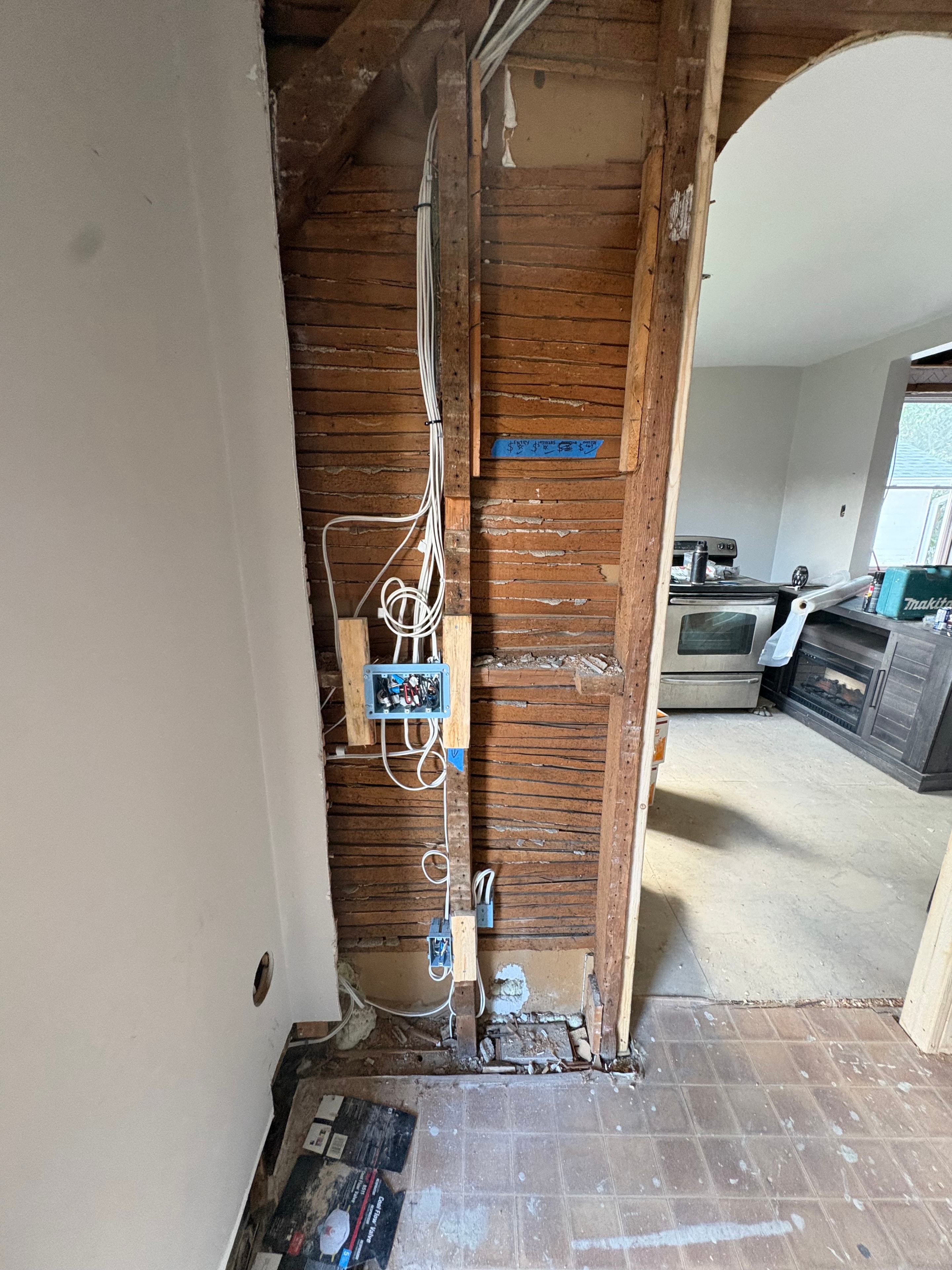 New branch-circuit wiring run along exposed lath wall framing with outlet boxes roughed in, part of the Smiths Falls home rewire