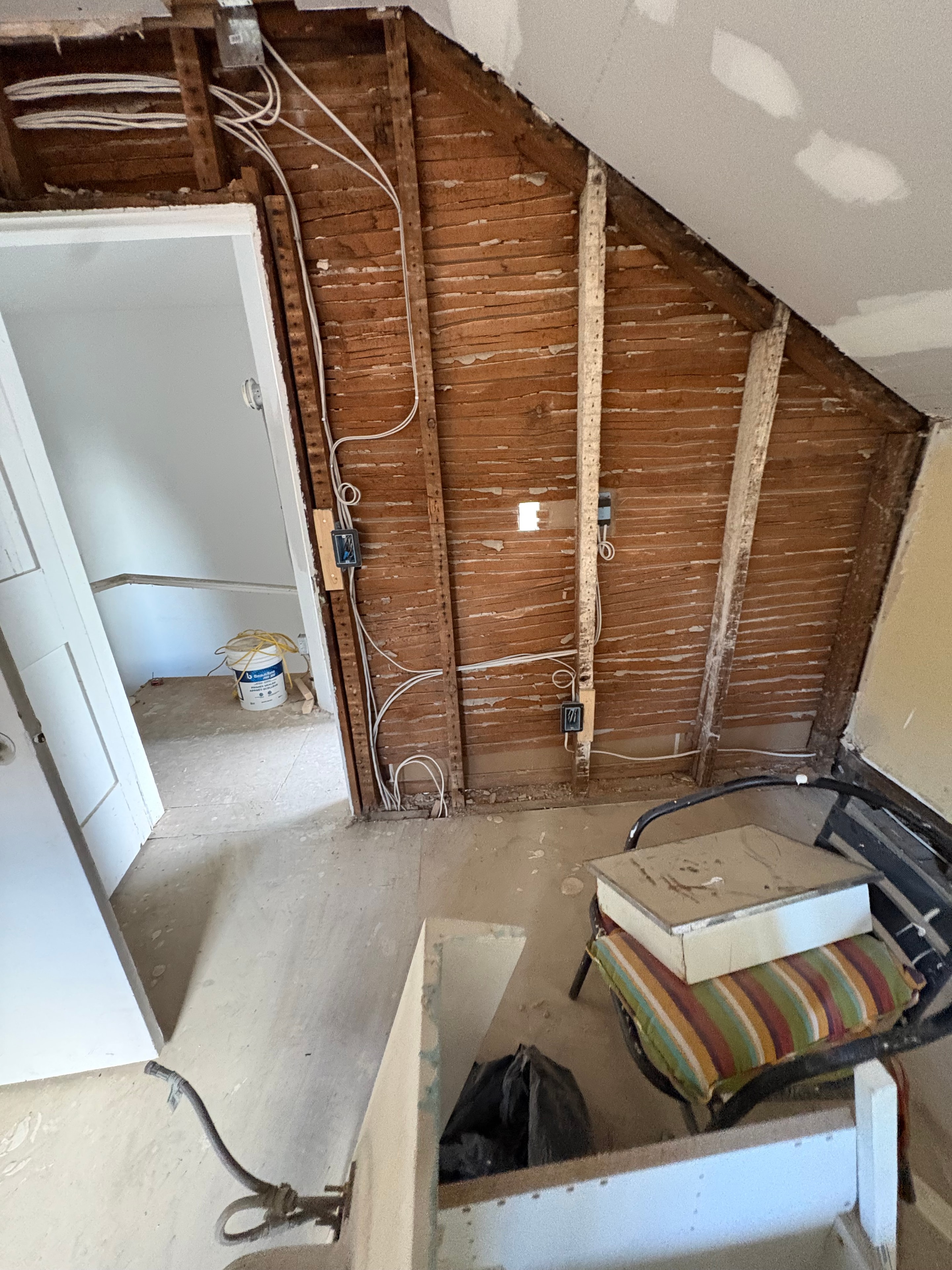 New branch-circuit cables routed across exposed lath framing bays with outlet boxes installed, showing the rewire in progress in a Smiths Falls home