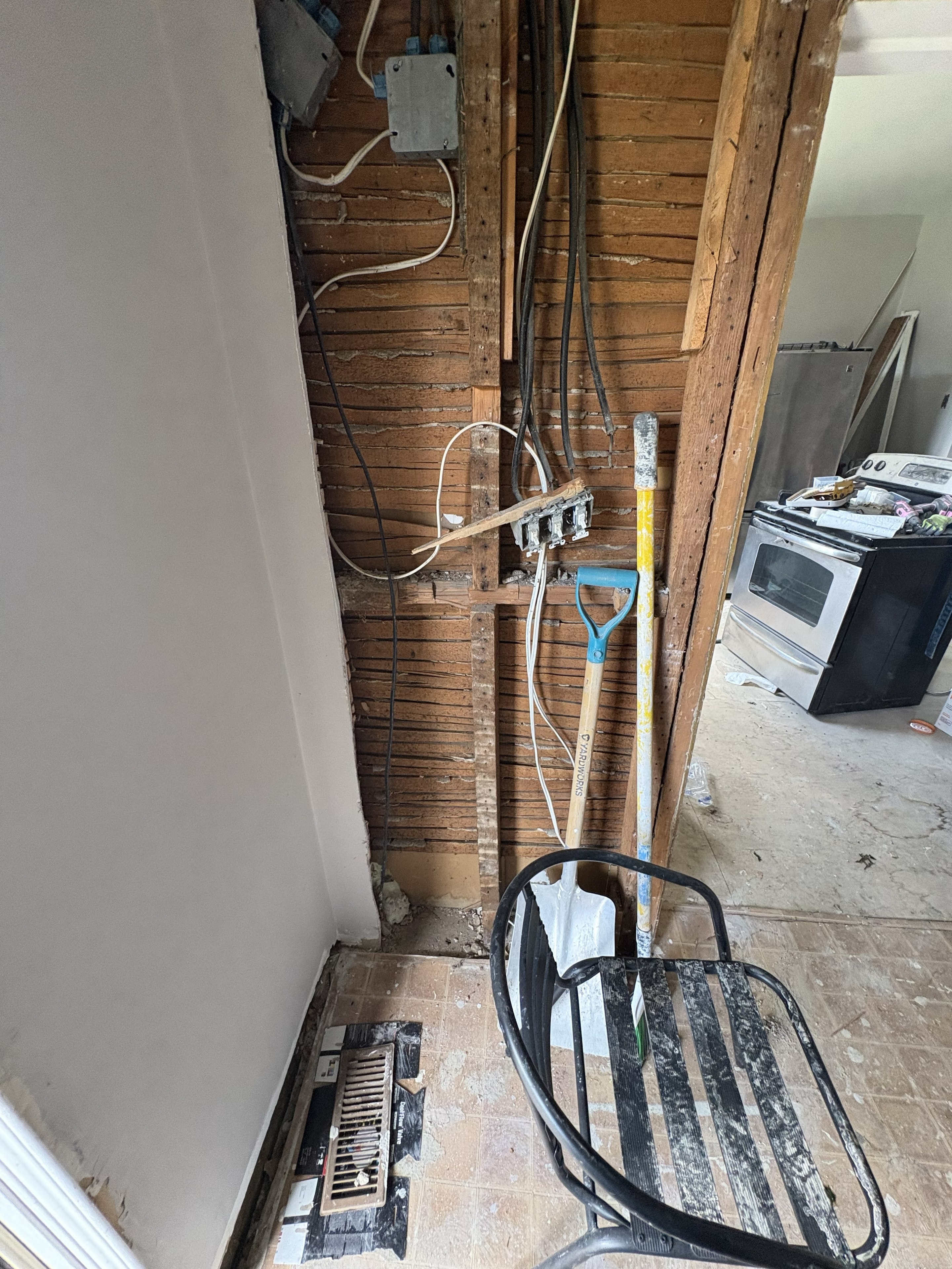 Exposed wall framing showing existing junction boxes, wiring and switches in a Smiths Falls home before electrical rewire